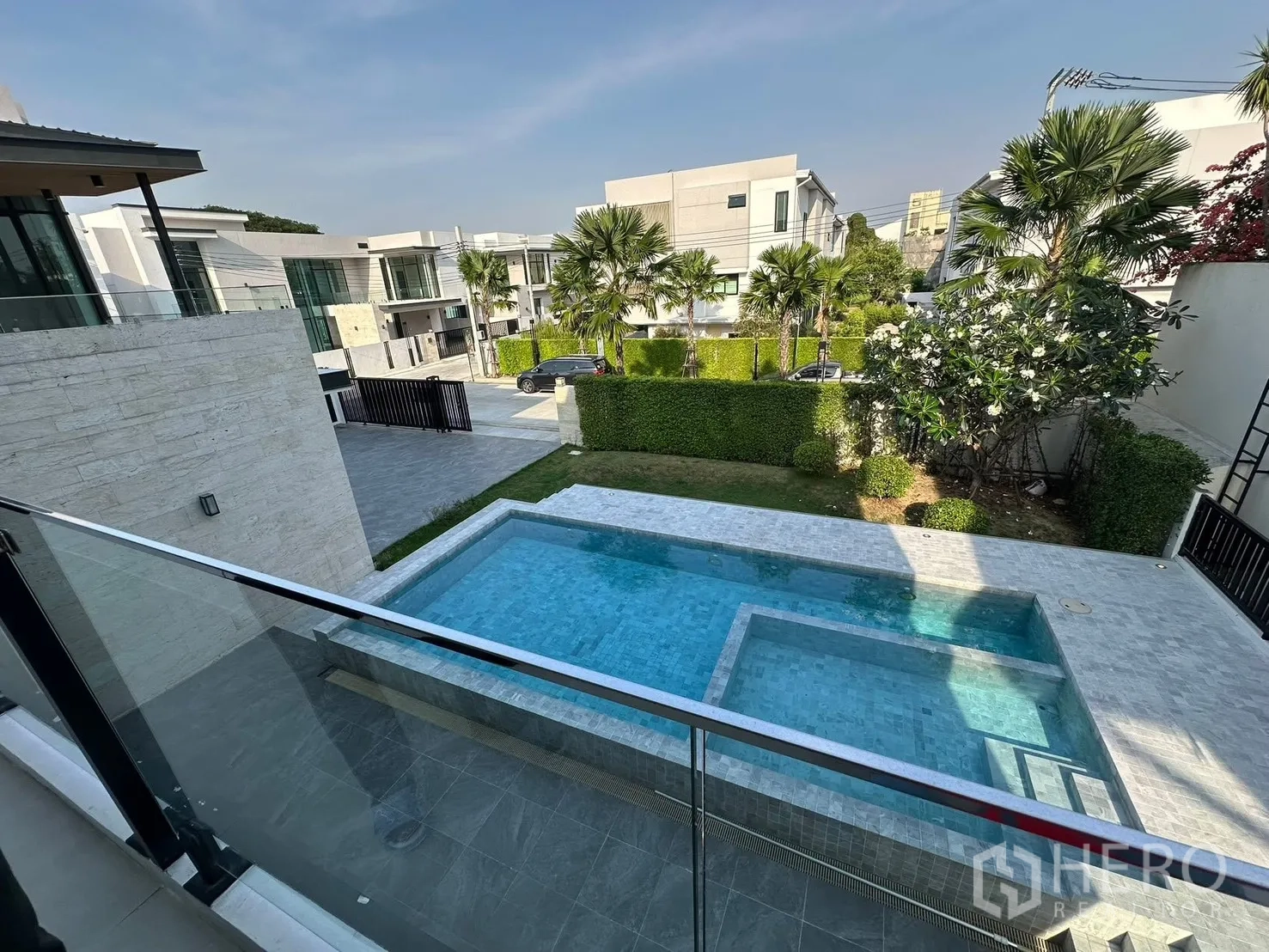 Detached House for sale in Bang Khen, Bangkok - Balcony view over a private swimming pool and modern neighboring villas.