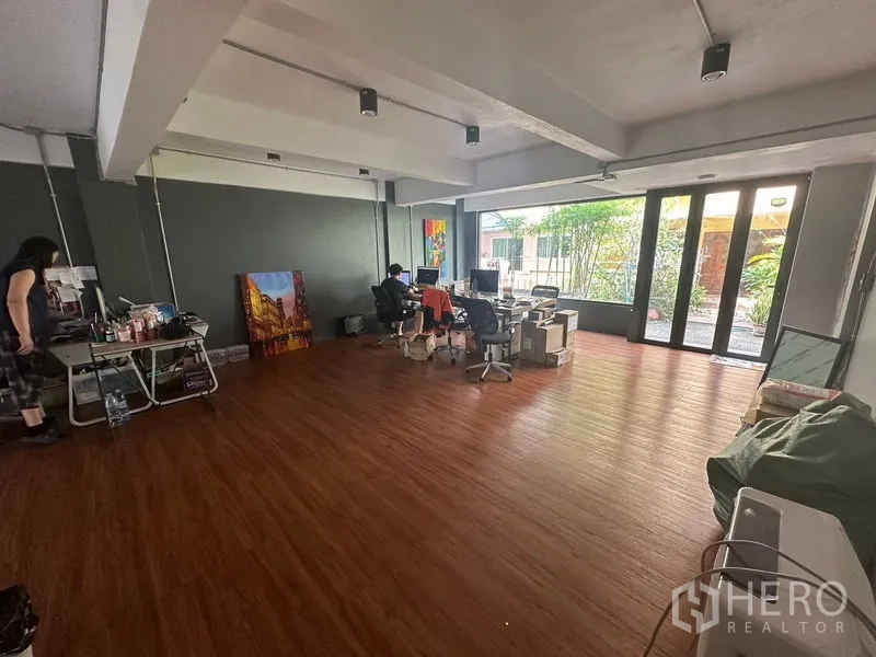 Home Office for rent in Sathon, Bangkok - Bright office area with sliding glass doors opening to a small garden patio.