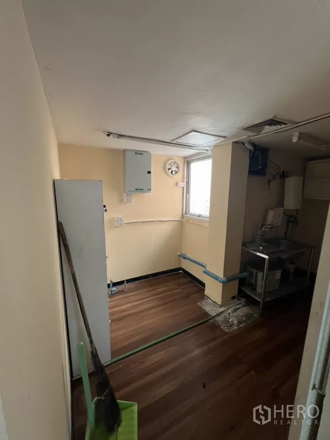 Retail Space for rent - Utility room with window, sink and exposed plumbing.