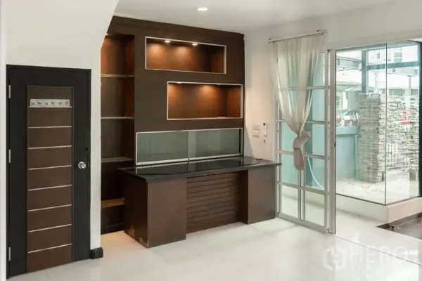 Home Office for rent in Lat Phrao, Bangkok - Ground-floor reception area with built-in wood cabinet and sliding glass doors.