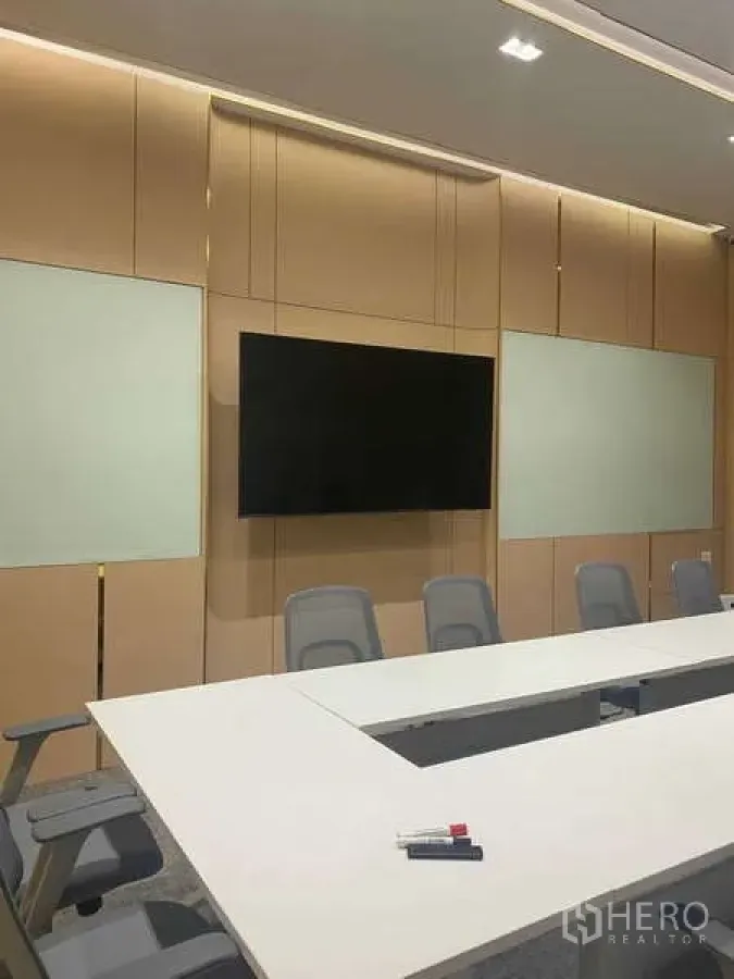 Office Space for rent in Huai Khwang, Bangkok - Boardroom wall with mounted flat-screen display, whiteboards and seating.