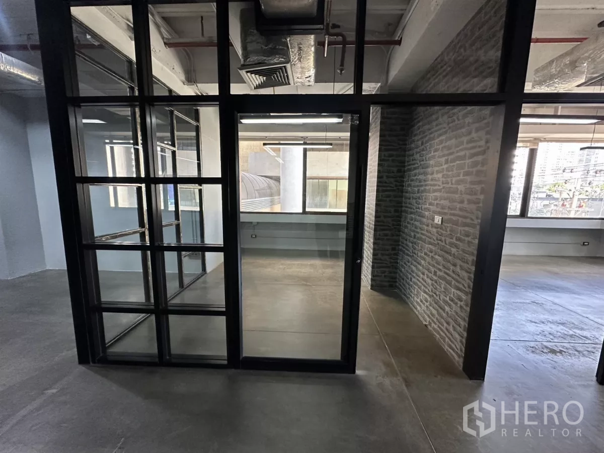 Office Space for rent - Glass door entry to enclosed office with industrial finishes.