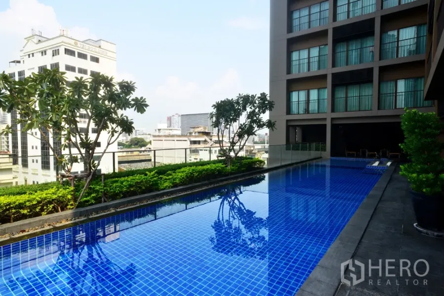 Condominium for rent in Bangkok - Rooftop lap pool with city skyline views and landscaped deck at Bangkok condominium.