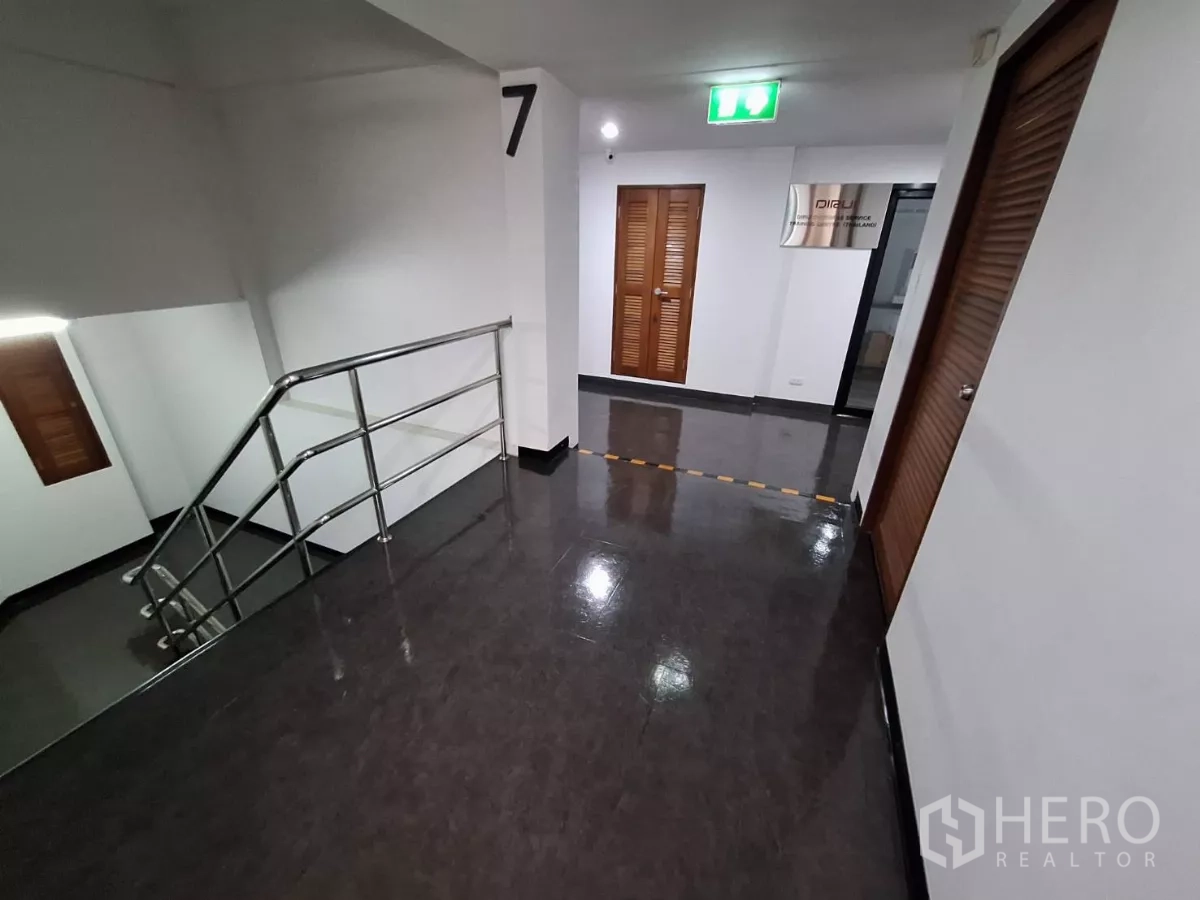 Office Space for rent in Watthana, Bangkok - Open office zone with black-framed glass wall and ceiling cassette air-conditioning.