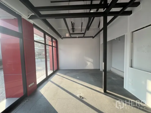 Retail Space for rent - Corner display zone with large glazing and exposed ceiling grid for lighting.