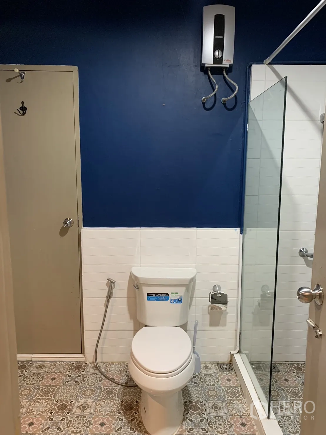 Townhouse for rent in Watthana, Bangkok - Bathroom with glass shower enclosure, toilet and water heater.