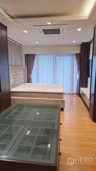 Detached House for sale in Sai Mai, Bangkok - Spacious master bedroom with large windows, balcony access and wood flooring.