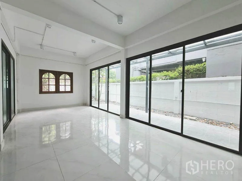 Home Office for rent in Lat Phrao, Bangkok - Bright ground-floor workspace with floor-to-ceiling sliding glass doors opening to the patio.