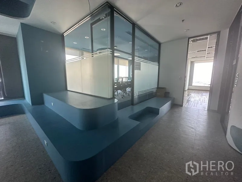 Office Space for rent in Ratchathewi, Bangkok - Glass-enclosed meeting room beside blue stepped seating platform.