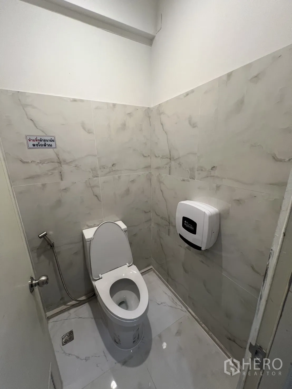 Retail Space for rent in Watthana, Bangkok - Clean tiled restroom with modern toilet, bidet spray and dispenser.