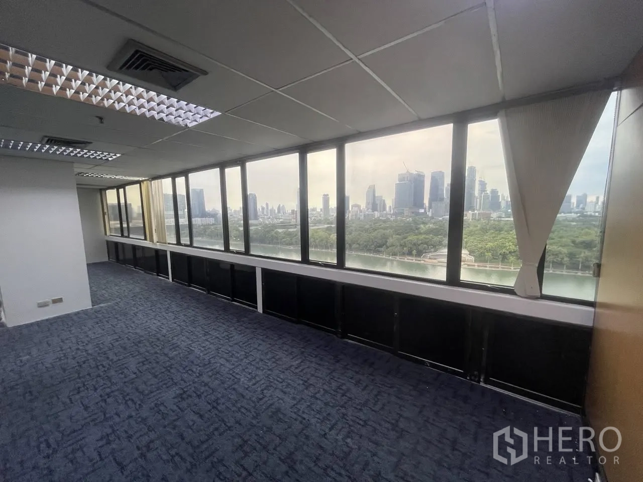 Office Space for rent in Khlong Toei, Bangkok - Long wall of wide windows showcasing park and skyline views.
