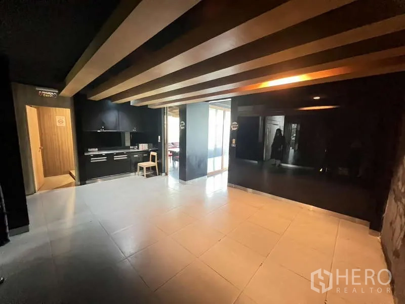 Shophouse for rent or sale in Khlong Toei, Bangkok - Reception or lobby-style area with black feature walls and timber ceiling beams.
