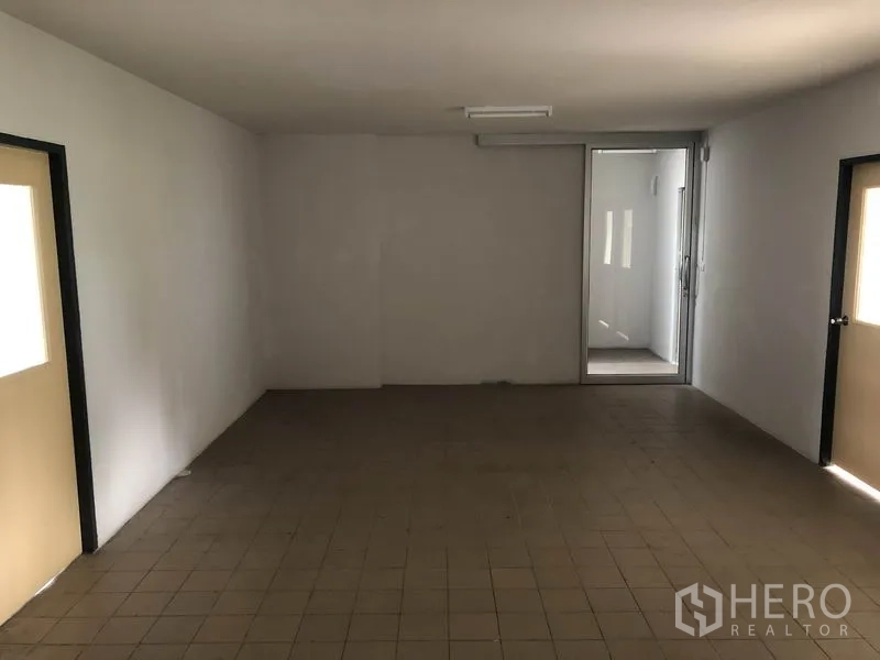 Factory for rent in Lam Luk Ka, Pathum Thani - Ground‑floor utility room with tiled floor and access to male and female restrooms.