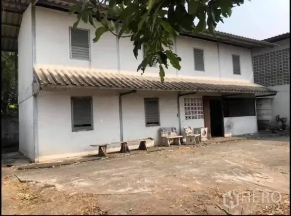 Factory for sale in Nong Chok, Bangkok - Two-storey office or staff quarters next to the main factory within a walled compound.
