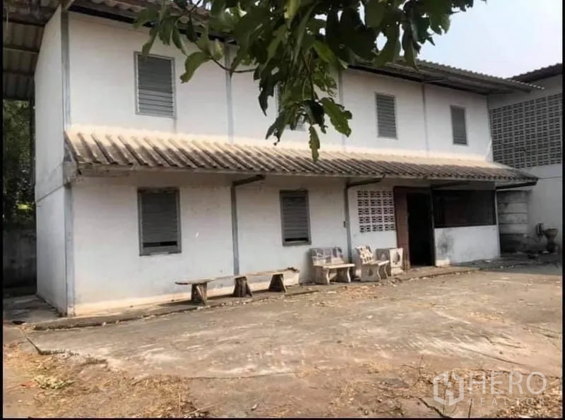 Factory for sale in Nong Chok, Bangkok - Two-storey office or staff quarters next to the main factory within a walled compound.