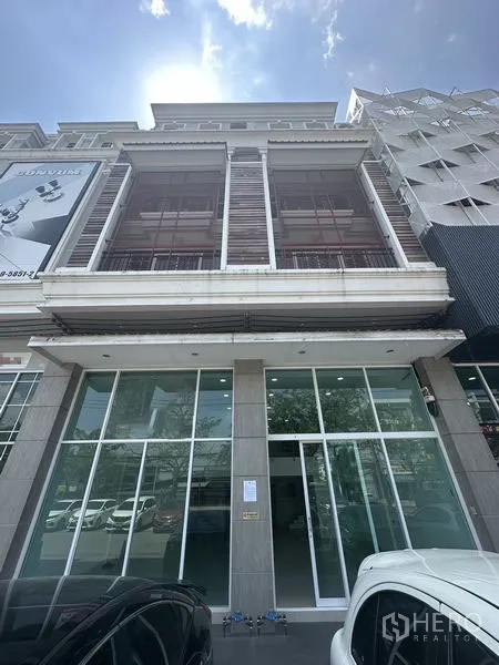 Home Office for rent in Bang Na, Bangkok - Modern home office facade with full-height glass storefront and balconies.