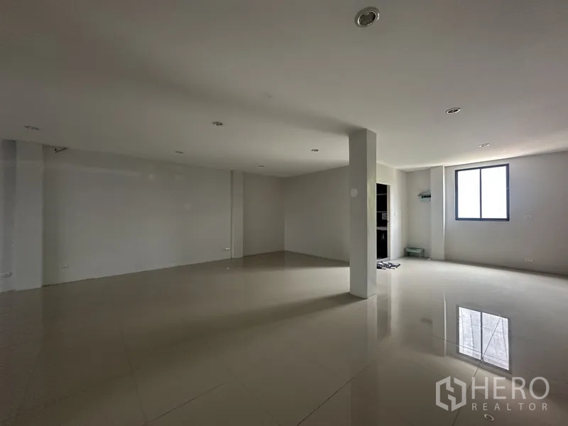 Home Office for rent or sale in Khlong Toei, Bangkok - Another expansive tiled workspace with columns and windows ready for fit‑out.