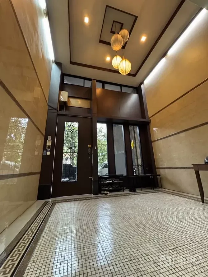 Shophouse for rent in Bang Rak, Bangkok - Main entrance lobby featuring tall wooden doors and recessed ceiling lights.