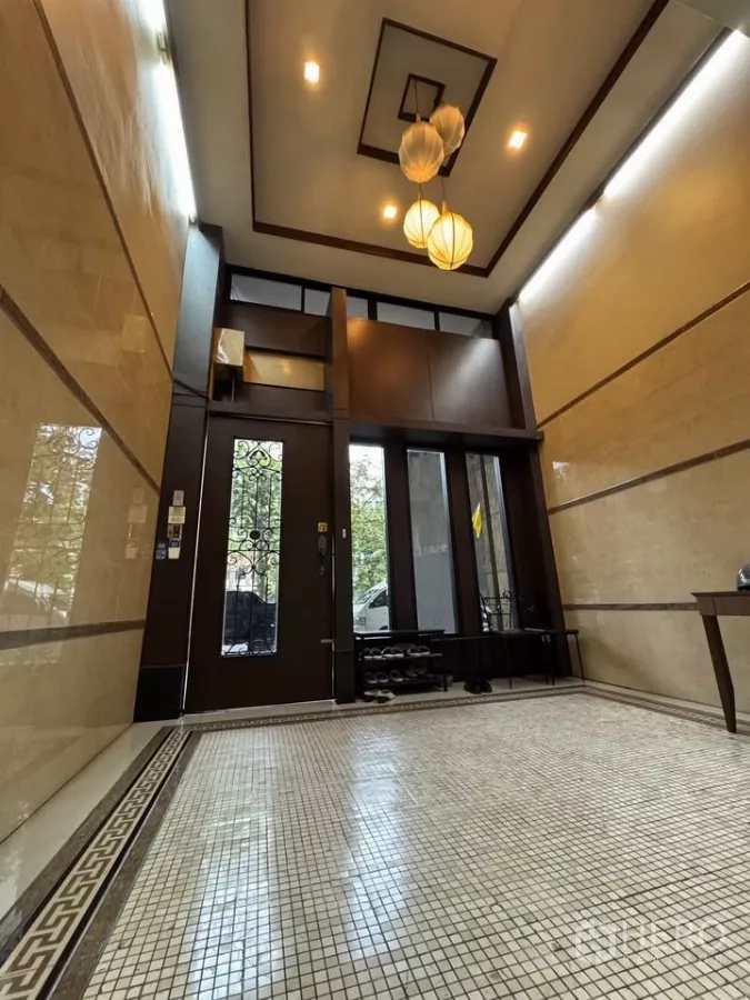 Shophouse for rent in Bang Rak, Bangkok - Main entrance lobby featuring tall wooden doors and recessed ceiling lights.