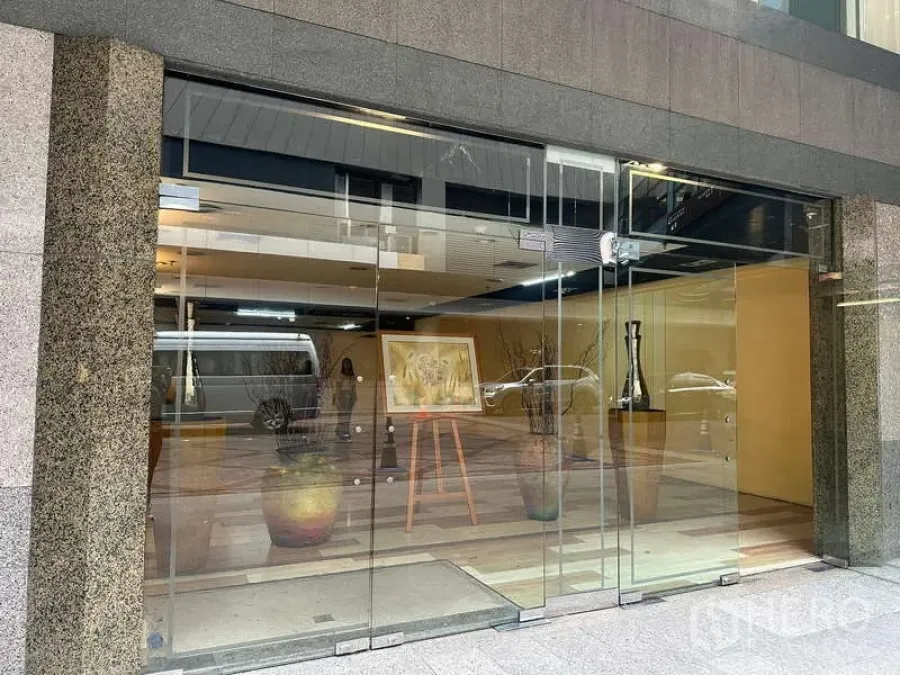 零售空间 出租 - 临街玻璃门面与推拉门，可见拱廊内的展示空间。