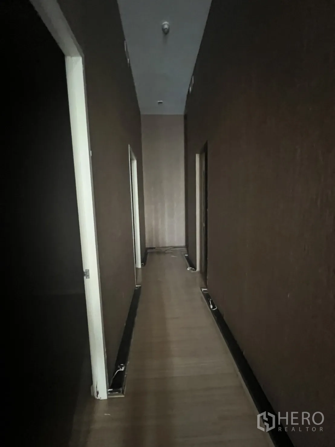 Retail Space for rent in Watthana, Bangkok - Hallway with several doors leading to small rooms and ceiling downlights.