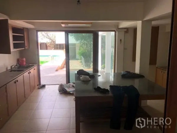 Detached House for rent in Watthana, Bangkok - Kitchen opening to pool terrace through large sliding glass doors.