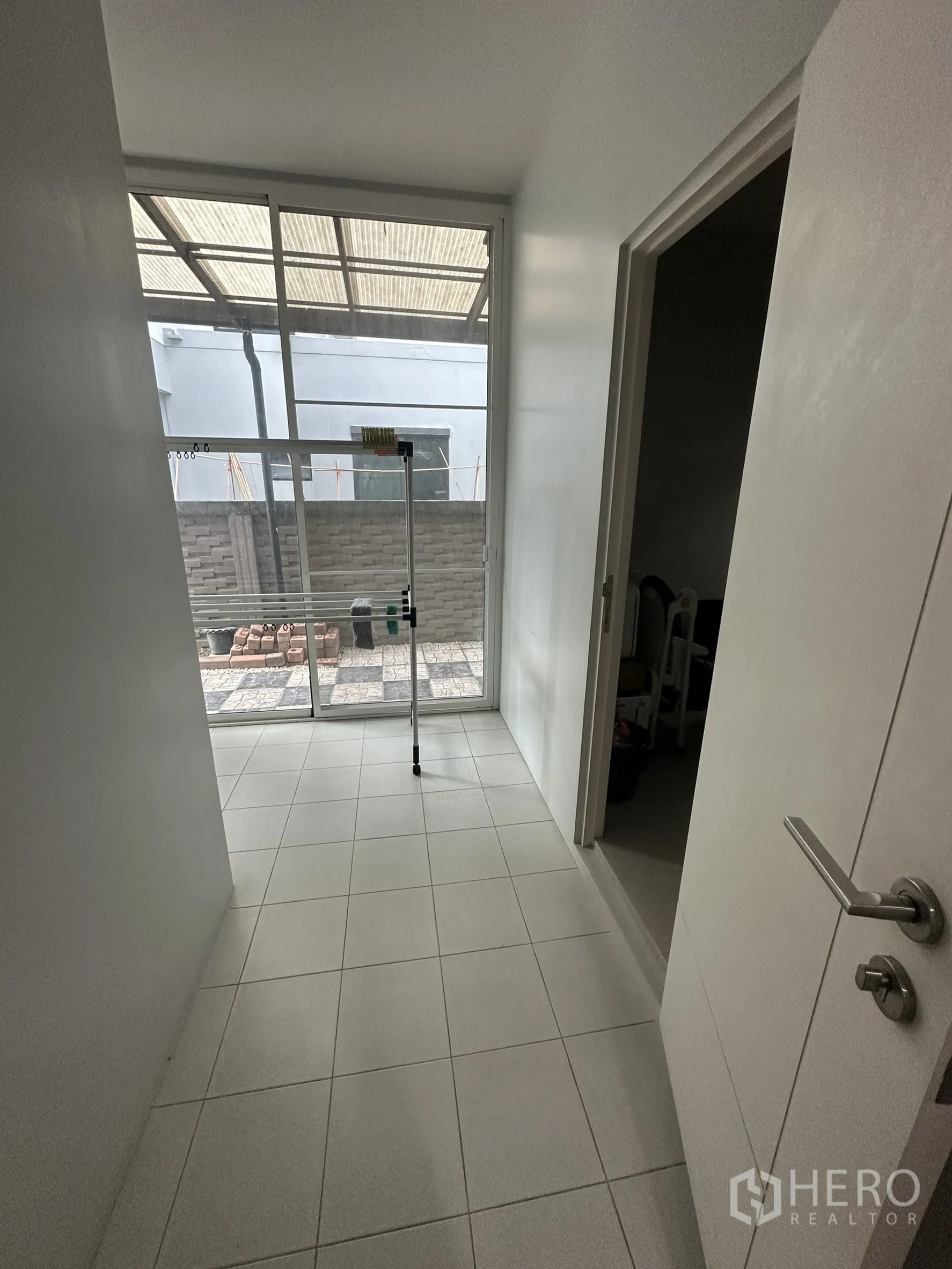 Detached House for rent in Lam Luk Ka, Pathum Thani - Utility room with tiled floor opening to covered side yard.