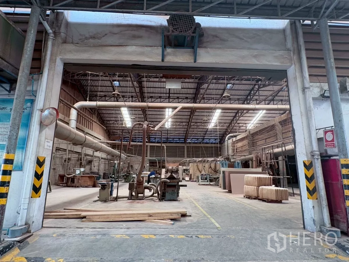 Factory for rent or sale in Bang Khun Thian, Bangkok - High-roof production hall with skylights, large extraction pipes and equipment.