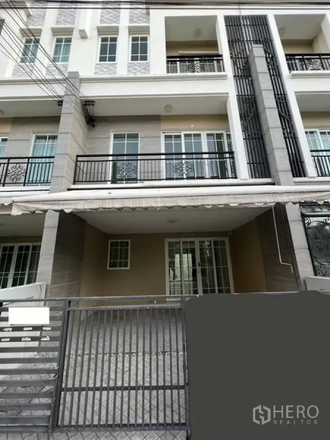 Home Office for rent or sale - Multi-storey home office facade in Bang Na with gated carport and balconies.