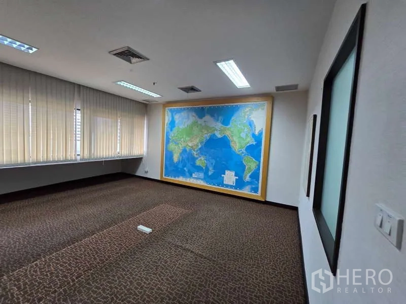 Office Space for rent in Khlong Toei, Bangkok - Spacious boardroom with world map feature wall and full-height blinds.