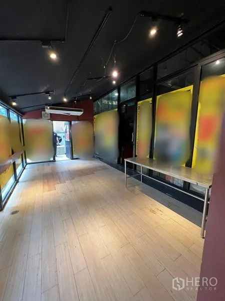 Retail Space for rent in Watthana, Bangkok - Open retail hall with floor-to-ceiling windows, track lighting and pale wood flooring.
