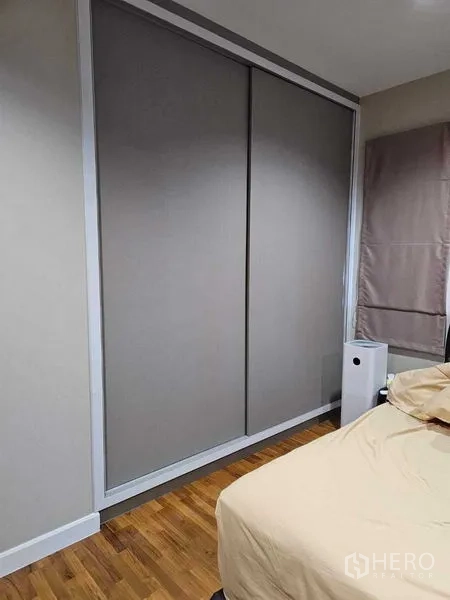 Detached House for sale in Khan Na Yao, Bangkok - Bedroom corner featuring a large sliding wardrobe and wood floors.