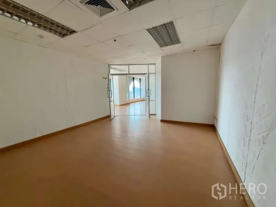 Office Space for rent in Chatuchak, Bangkok - Enclosed room with double glass doors leading to a sunlit office area.