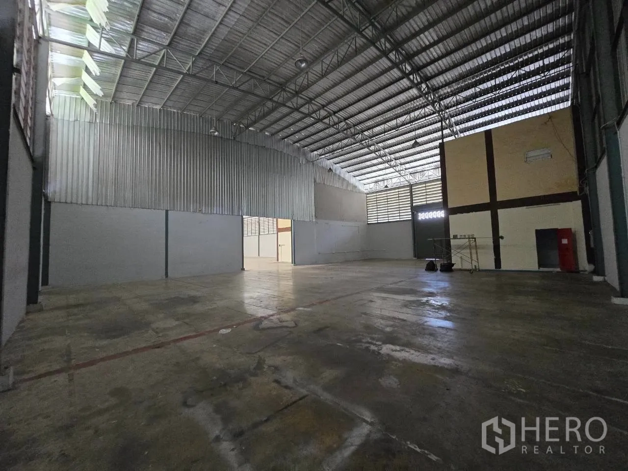 Warehouse for rent or sale in Mueang Samut Sakhon, Samut Sakhon - Interior warehouse hall with a high steel truss roof and concrete floor.