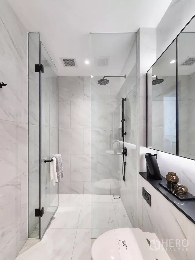 Condominium for rent in Bang Rak, Bangkok - Sleek secondary bathroom featuring a glass-enclosed rain shower and stone countertop.