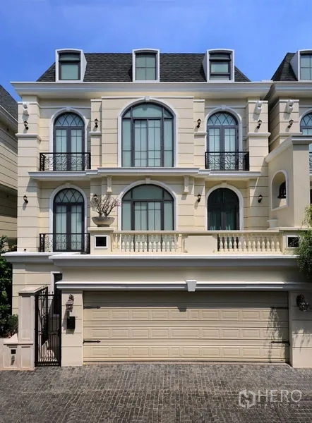 Detached House for rent or sale in Watthana, Bangkok - Front elevation of the three-storey detached house with balconies and garage.