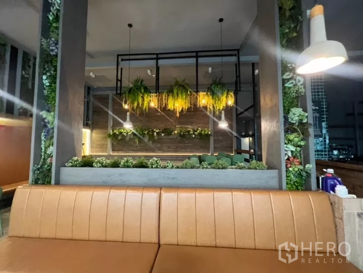 Retail Space for rent - View from banquette toward planter divider and warm hanging lighting.