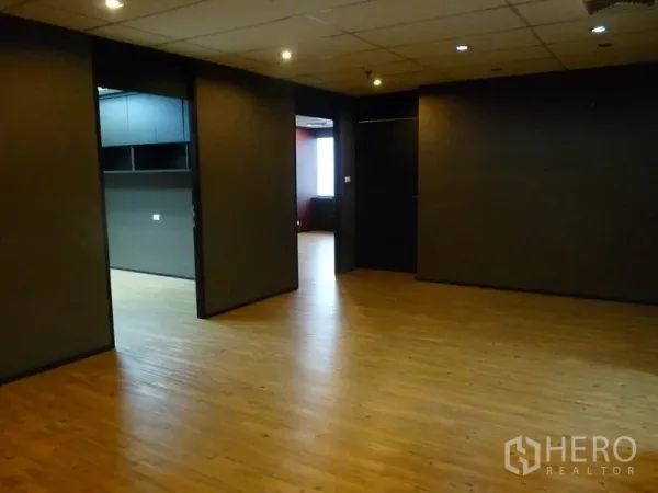 Office Space for rent in Watthana, Bangkok - Flexible office area with wood floors, multiple doorways and warm downlights, ideal for team zones.
