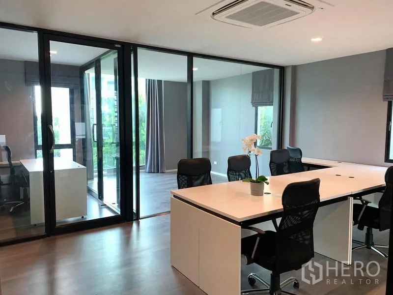 Home Office for rent - Open-plan office area with workstation cluster and glass-walled meeting rooms.