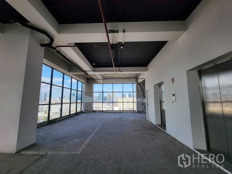 Retail Space for rent in Sathon, Bangkok - Lift lobby and unfinished retail floor with wide windows and city views in a Sathon building.