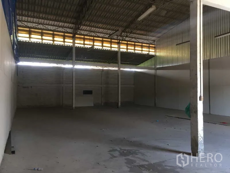 Warehouse for rent in Min Buri, Bangkok - Spacious warehouse interior with high metal roof, steel columns and an open clear floor ready for storage.