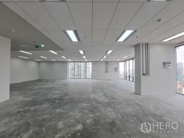 Office Space for rent in Chatuchak, Bangkok - Large open‑plan office floor with 3 m ceiling and full‑height windows overlooking Bangkok.