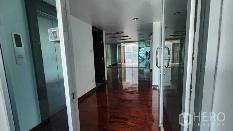 Shophouse for rent in Khlong Toei, Bangkok - Bright shophouse floor with glass doors and polished wood flooring, ready for retail or office use.