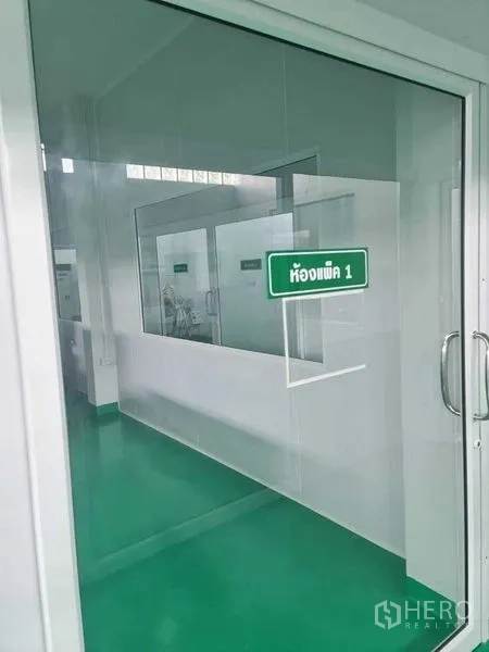 Factory for sale in Bang Pa-in, Phra Nakhon Si Ayutthaya - Glass door labeled packing room 1 looking into a clean workspace.
