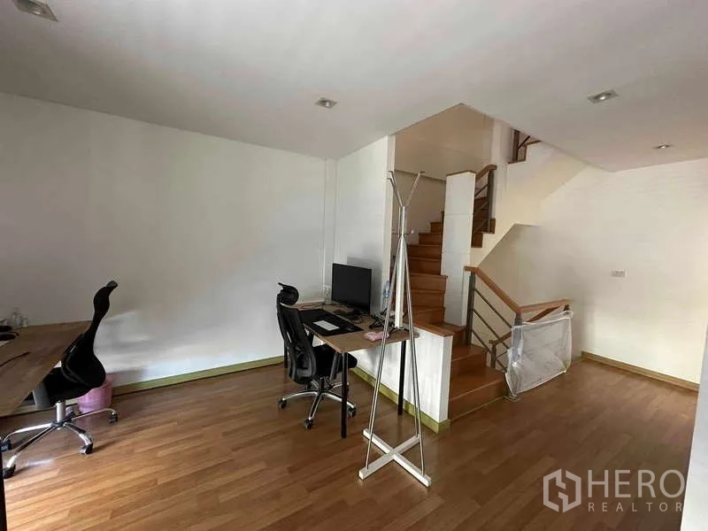 Home Office for rent in Chatuchak, Bangkok - Open-plan office area beside the staircase with desks and task chairs.