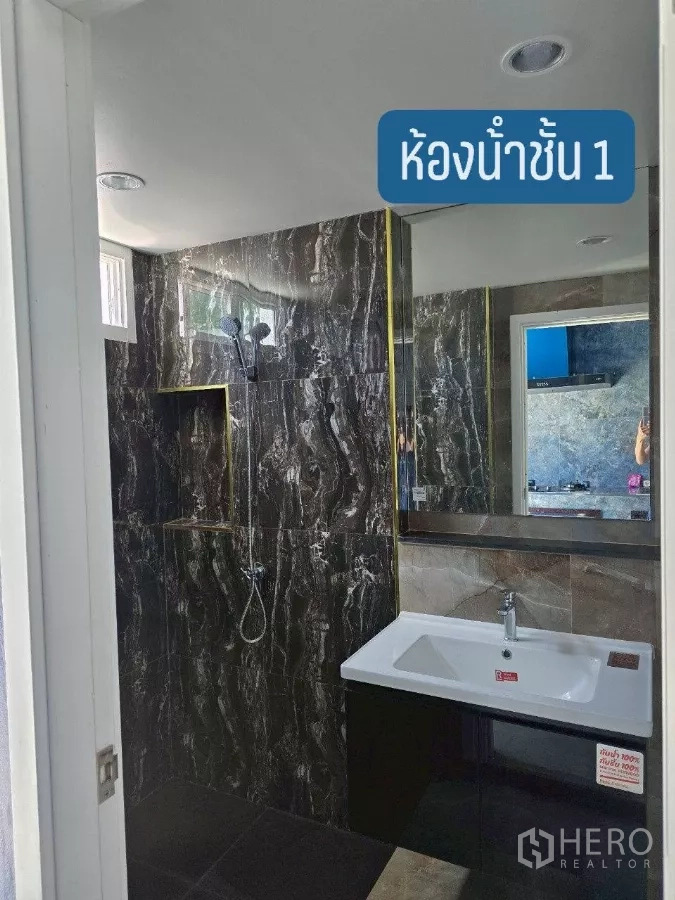 Warehouse for rent or sale in Khlong Toei, Bangkok - Modern ground-floor bathroom with stone-look tiles, shower and vanity.