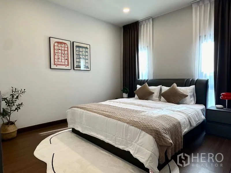 Detached House for rent in Bang Phli, Samut Prakan - Guest bedroom with framed art, upholstered bed and warm lighting.