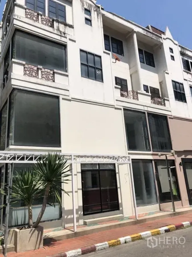 Retail Space for rent in Khlong Toei, Bangkok - Four-storey retail townhouse exterior with floor-to-ceiling windows and a pedestrian walkway.