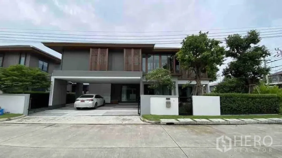 Detached House for rent or sale in Prawet, Bangkok - Modern two-storey detached house facade with double carport and driveway.