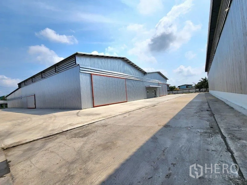Factory for rent in Mueang Samut Sakhon, Samut Sakhon - Driveway between warehouse buildings providing easy truck access and parking.